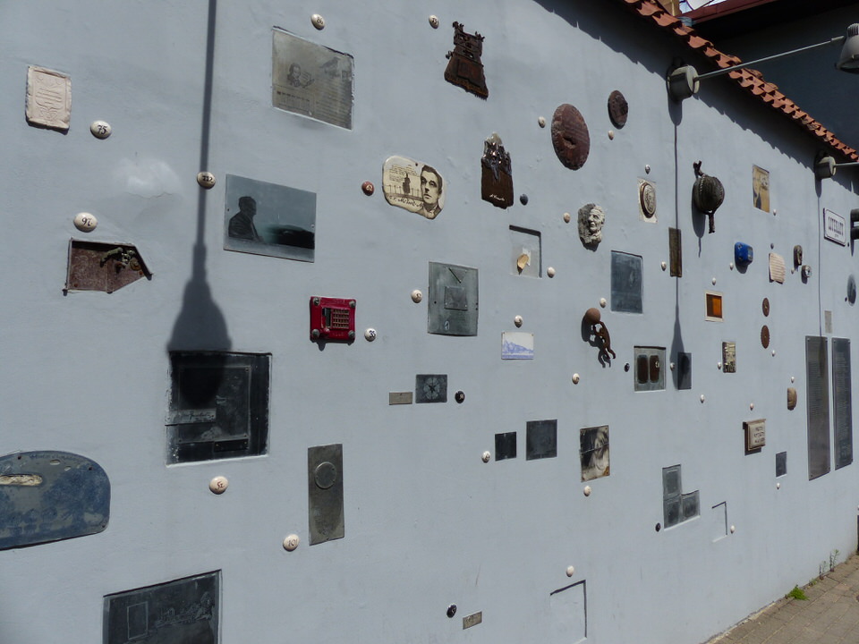 A street with plaques on the walls celebrating different literary artists.